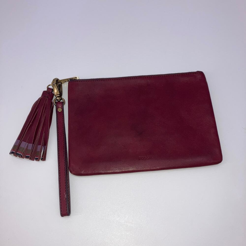 Fossil (Medium size) maroon leather wristlet with tassel.